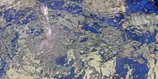 water moving in a blue and white tiled pool in hammam bath