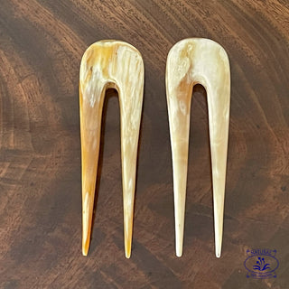 a pair of light coloured french pins