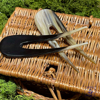 a dark and light coloured french hair pin on a basket