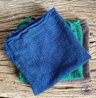 lint free eco cleaning cloths on oak bench. indigo, teal and grey