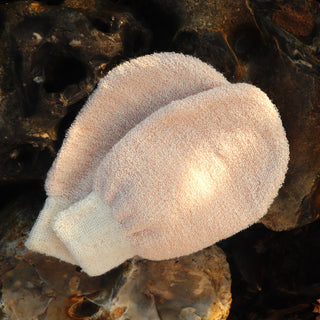 a pair of copper andd nettle exfoliating gloves on bolders