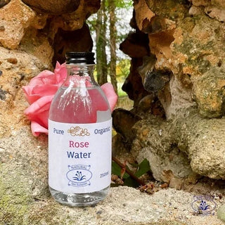 pure organic rose water with rose on masonry