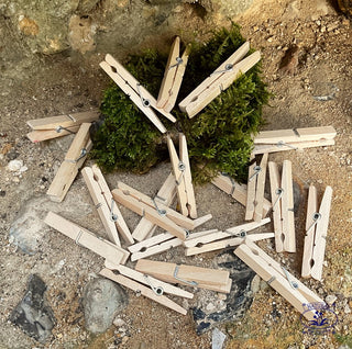 wooden pegs on flint wall with moss