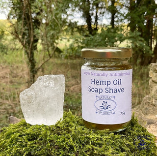 eco shaving kit, with hemp soap and alum styptic deodorant on moss in wood